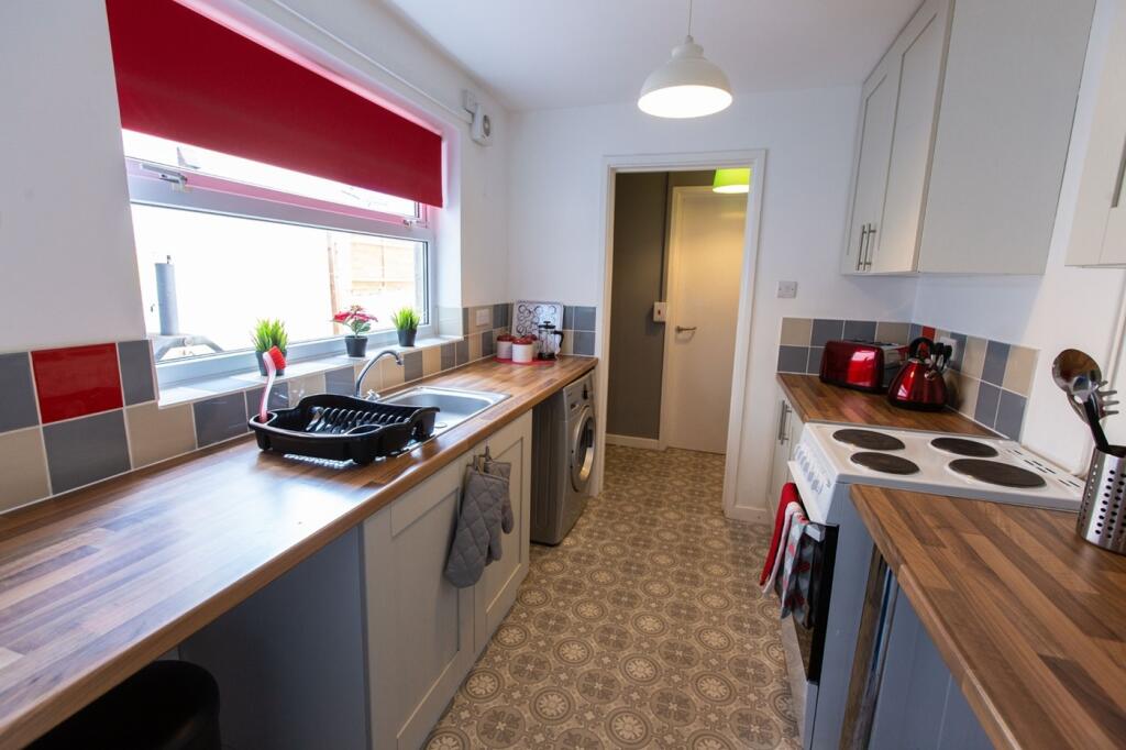 A clean and bright kitchen with modern applianc...
