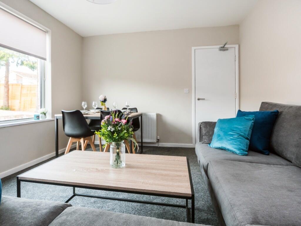 Bright and inviting living room featuring comfo...