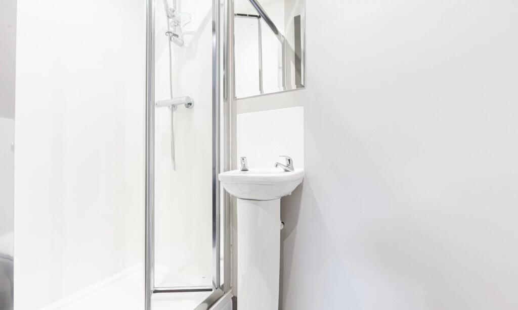 A modern, bright bathroom featuring a clean sho...