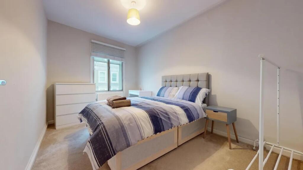 A cozy double bedroom featuring a comfortable b...