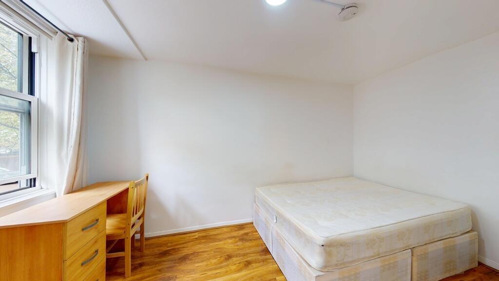 A clean and bright bedroom with a large window ...