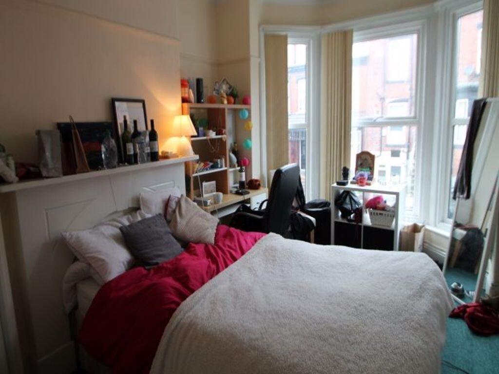 A cozy bedroom featuring a double bed with plus...