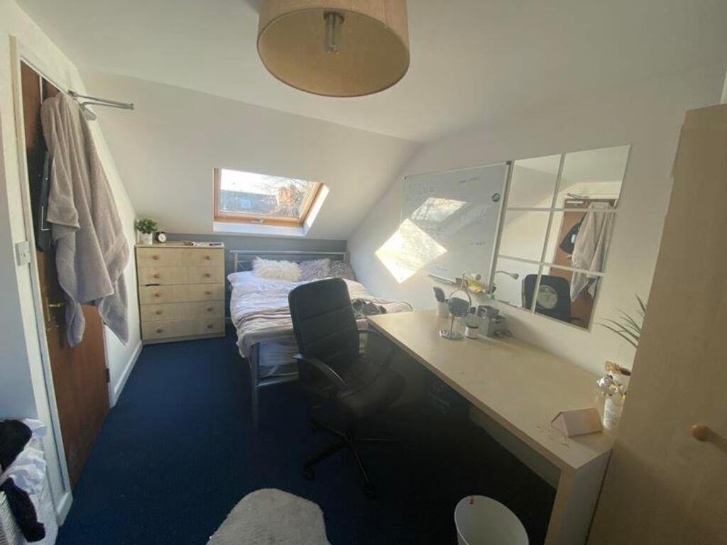 A bright and inviting double bedroom with a coz...