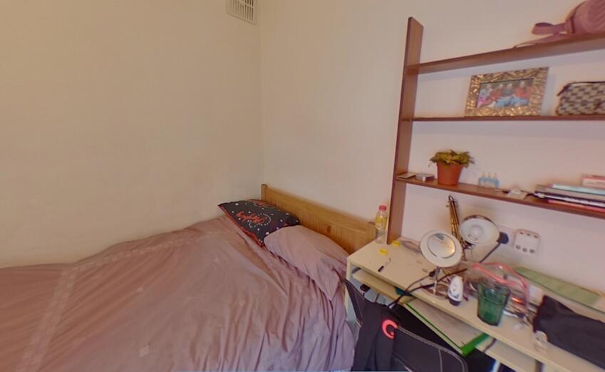 Cozy and simple room featuring a neatly made si...