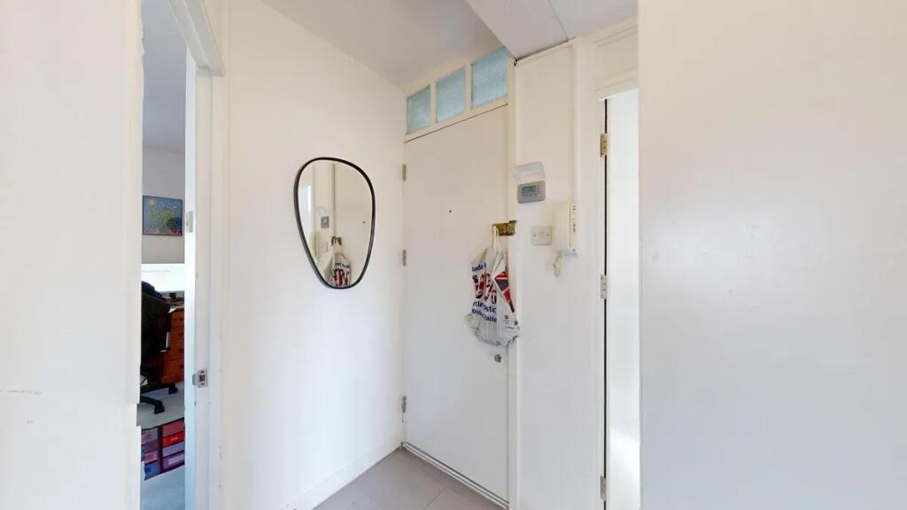 Bright and clean hallway with white walls, a wa...