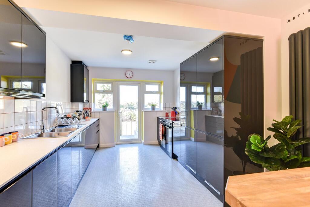 A modern and inviting kitchen featuring sleek c...