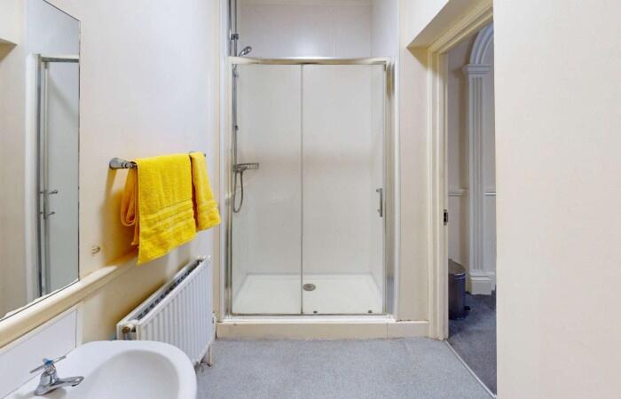 Bright and clean bathroom featuring a spacious ...
