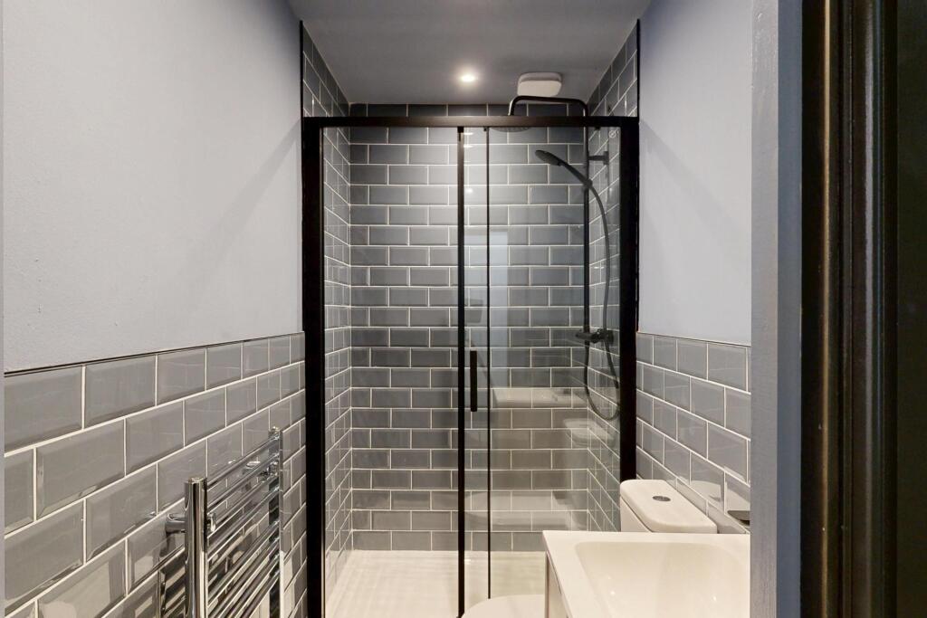 A modern, clean bathroom with a spacious shower...