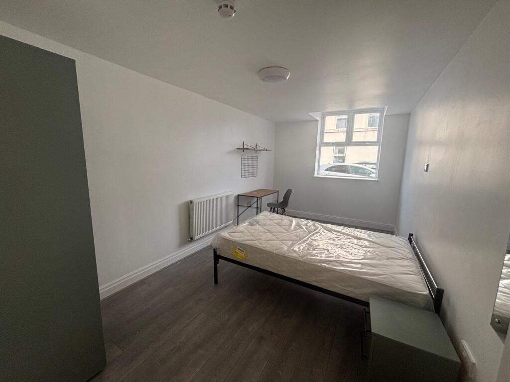 Spacious double bedroom featuring a comfortable...
