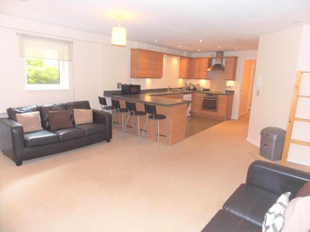 Spacious open-plan living room with comfortable...