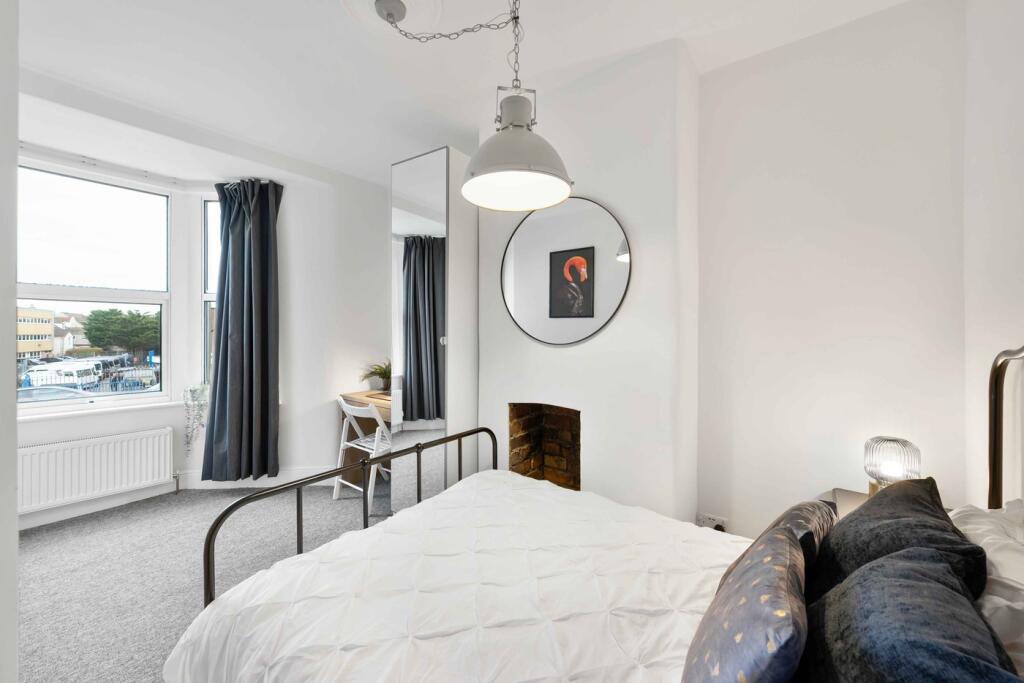 A modern and inviting double bedroom with ample...