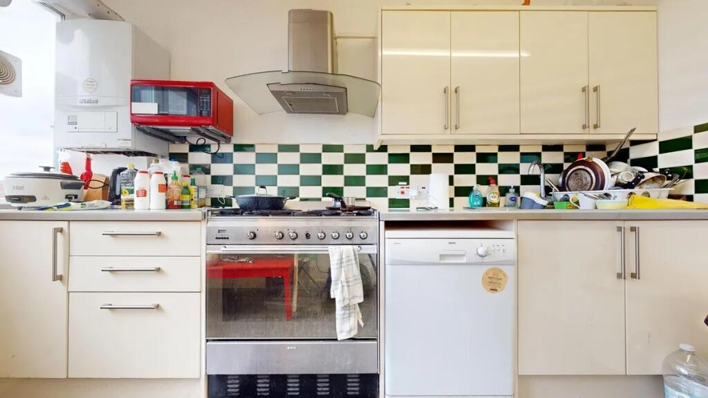 Bright kitchen with modern appliances including...