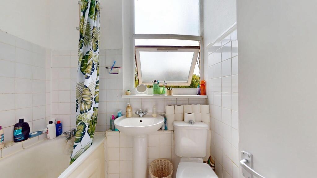 Bright and clean bathroom featuring a full-size...