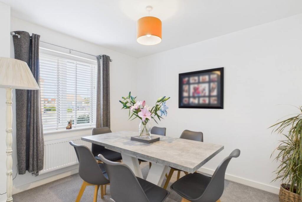 Spacious and neutrally decorated this dining room 