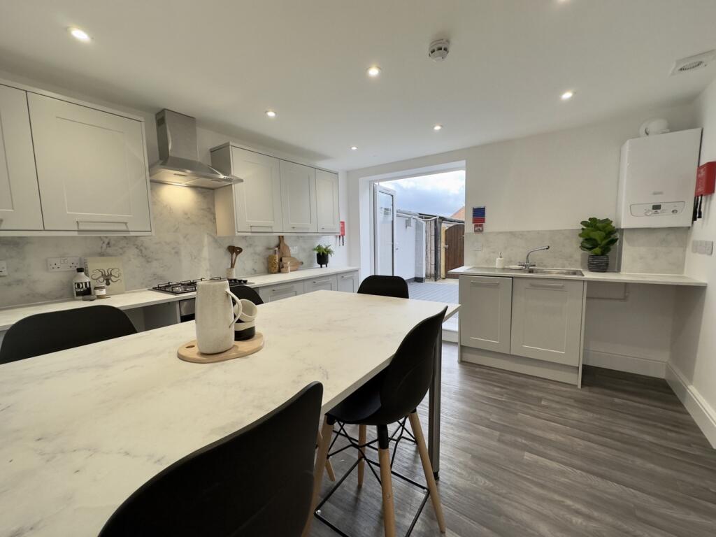 A modern and spacious kitchen with ample natura...