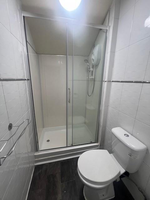 Bright, modern bathroom with a full shower encl...