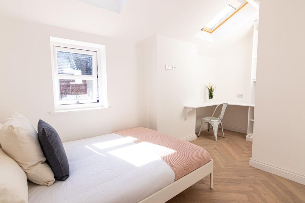 Bright and airy bedroom featuring a comfortable...