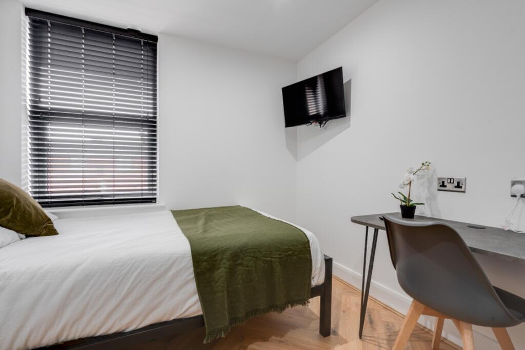 A bright and clean double bedroom featuring a c...