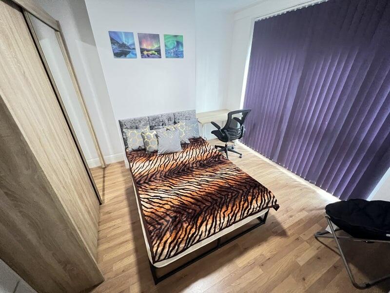 A stylish double bedroom featuring a comfortabl...