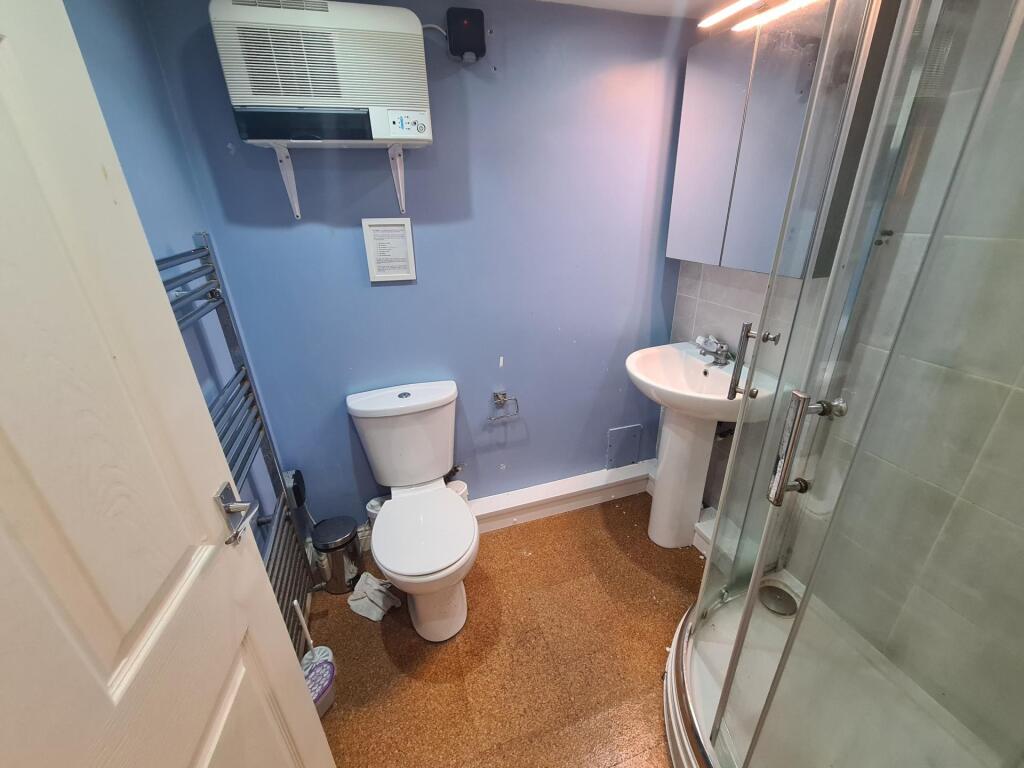 A well-maintained bathroom featuring a curved g...