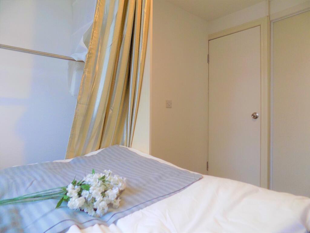 Bright and tidy single bedroom featuring clean ...