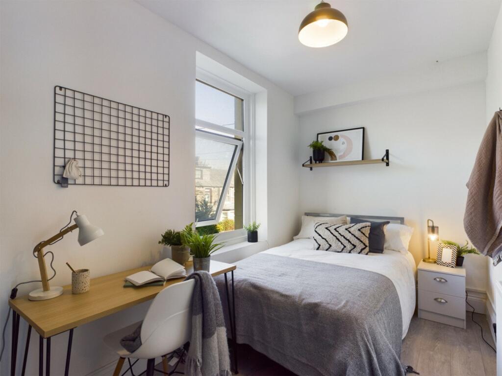 A bright and inviting double bedroom with moder...