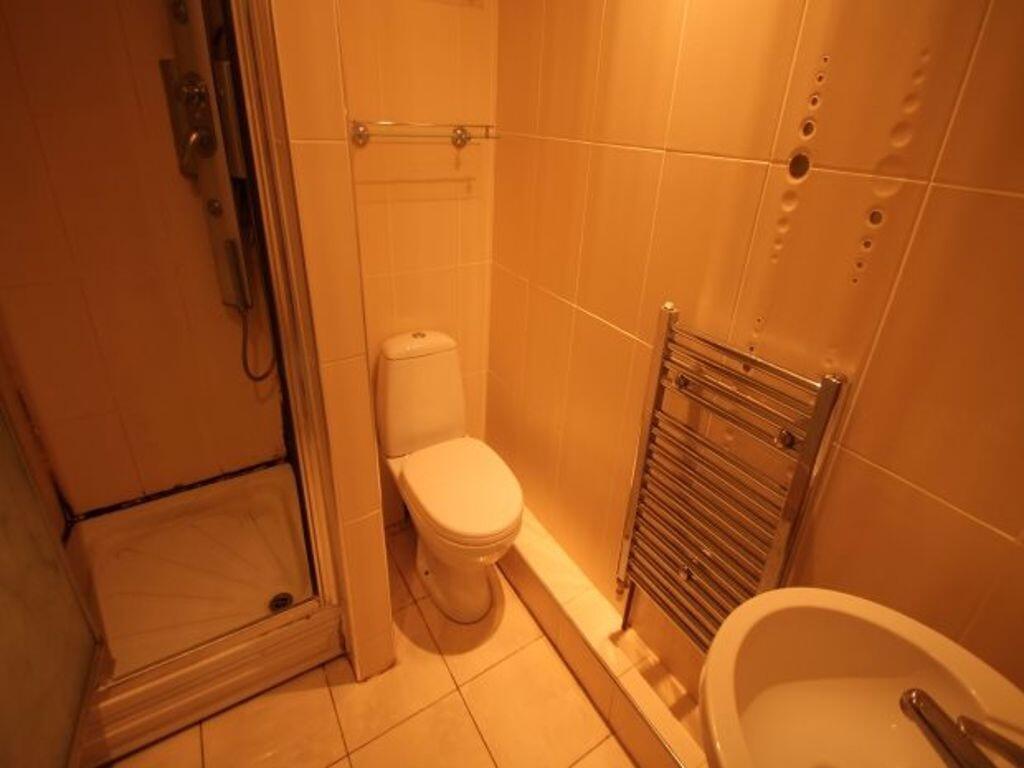 A compact, clean bathroom featuring a toilet, h...