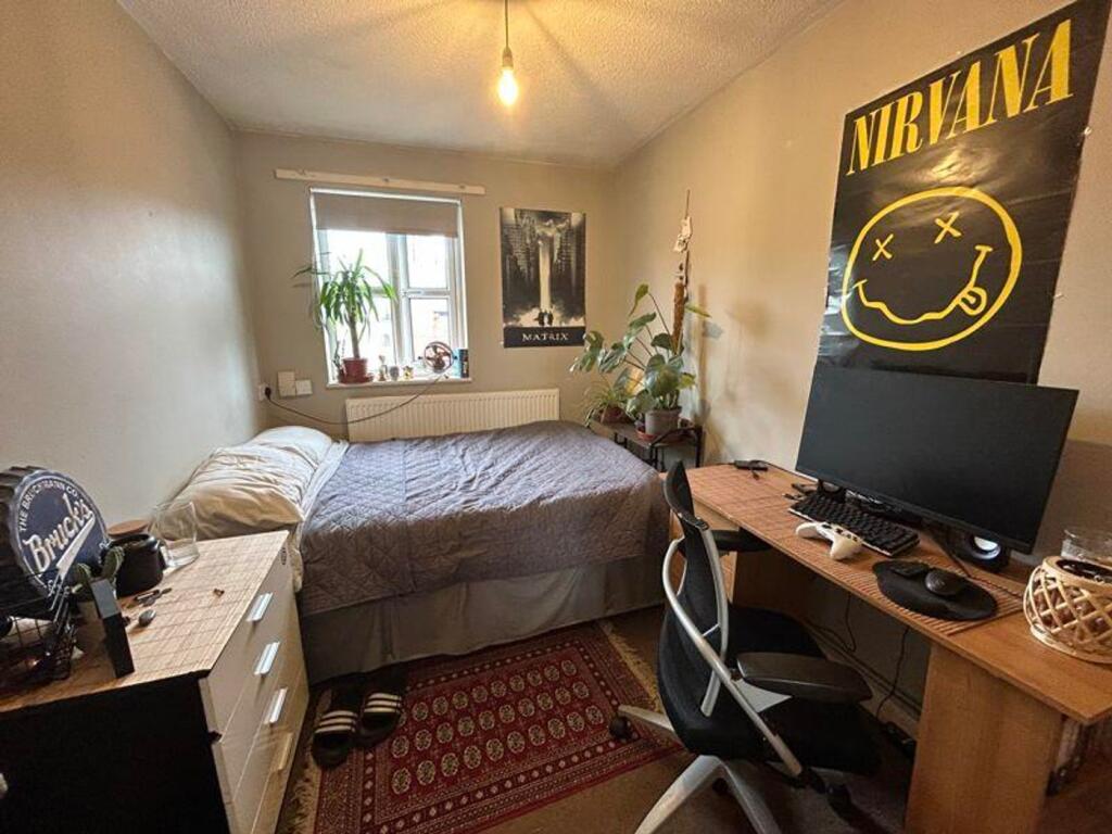 A cozy double bedroom with stylish decor, suita...