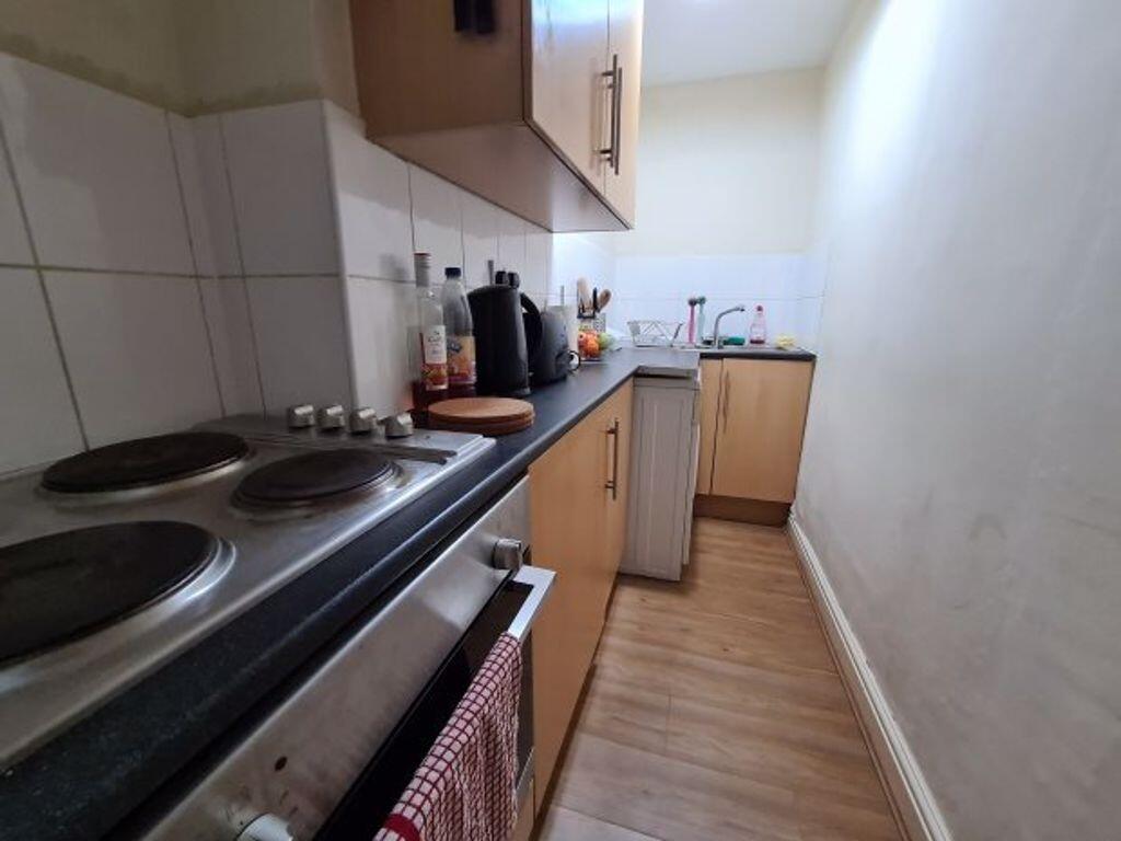 A compact kitchen with basic appliances and goo...