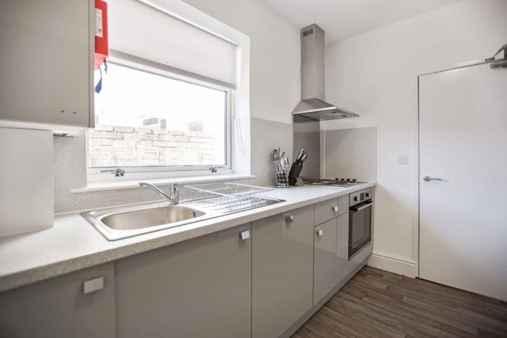Modern kitchen featuring sleek cabinetry and am...