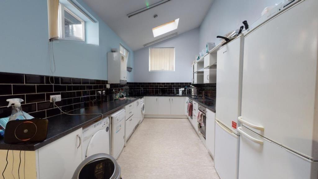 Bright and clean kitchen featuring modern black...