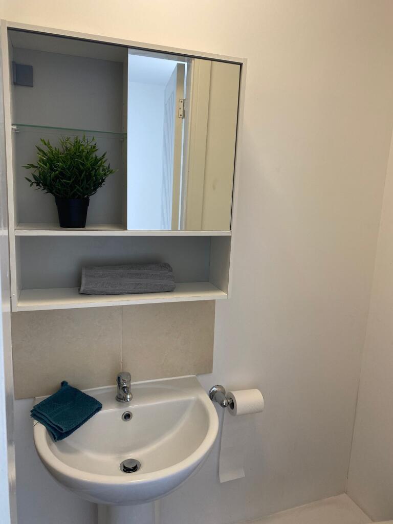 A modern bathroom featuring a sleek sink and st...