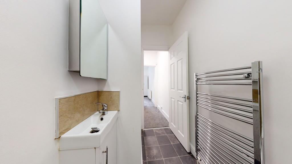 A clean and modern hallway featuring a sleek wh...