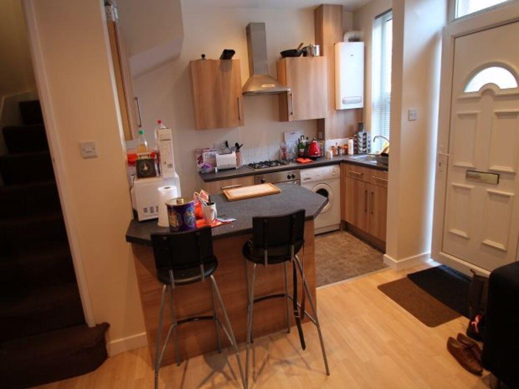 A modern kitchen area featuring a breakfast bar...