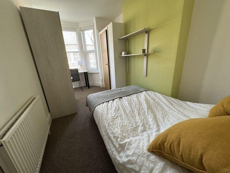 Bright and tidy single bedroom featuring a cozy...
