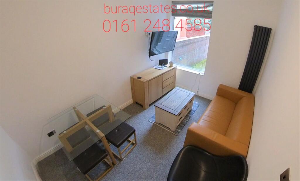 Bright, simply furnished living room with a com...