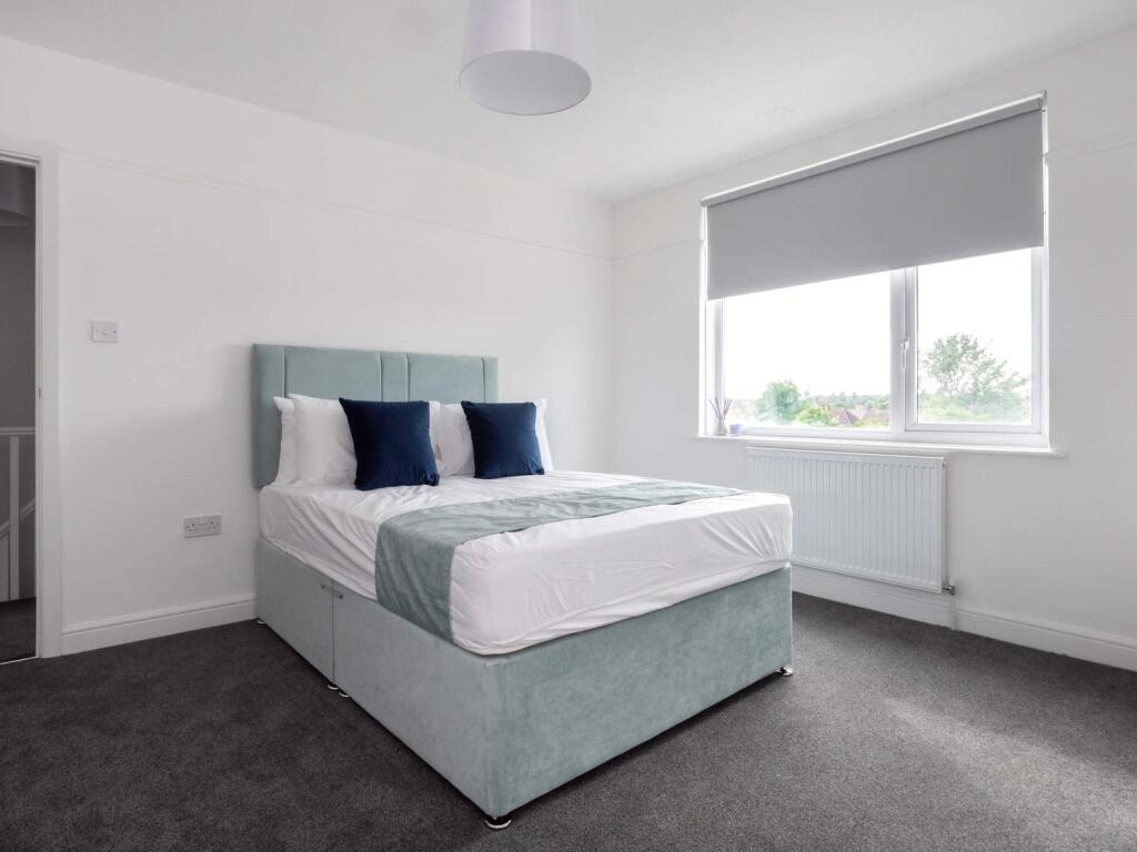 A bright and airy double bedroom featuring a co...