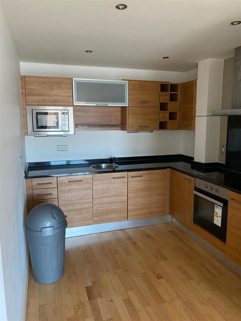 Modern kitchen featuring wooden cabinetry, inte...