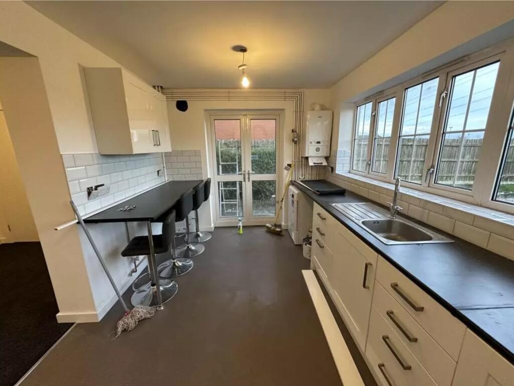 A bright and functional kitchen with ample coun...