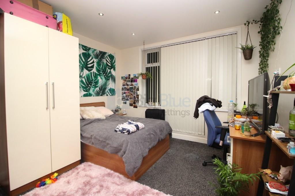 A cozy double bedroom featuring a comfortable d...