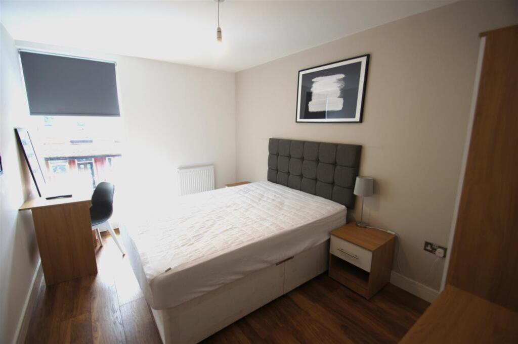 A bright and spacious double bedroom featuring ...