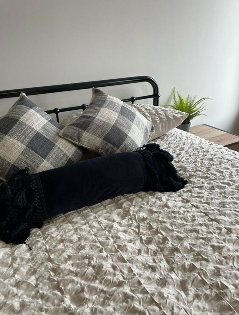 This stylish double bedroom features a cozy bed...