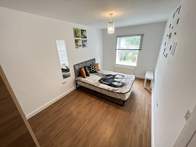 Bright and tidy double bedroom featuring a comf...