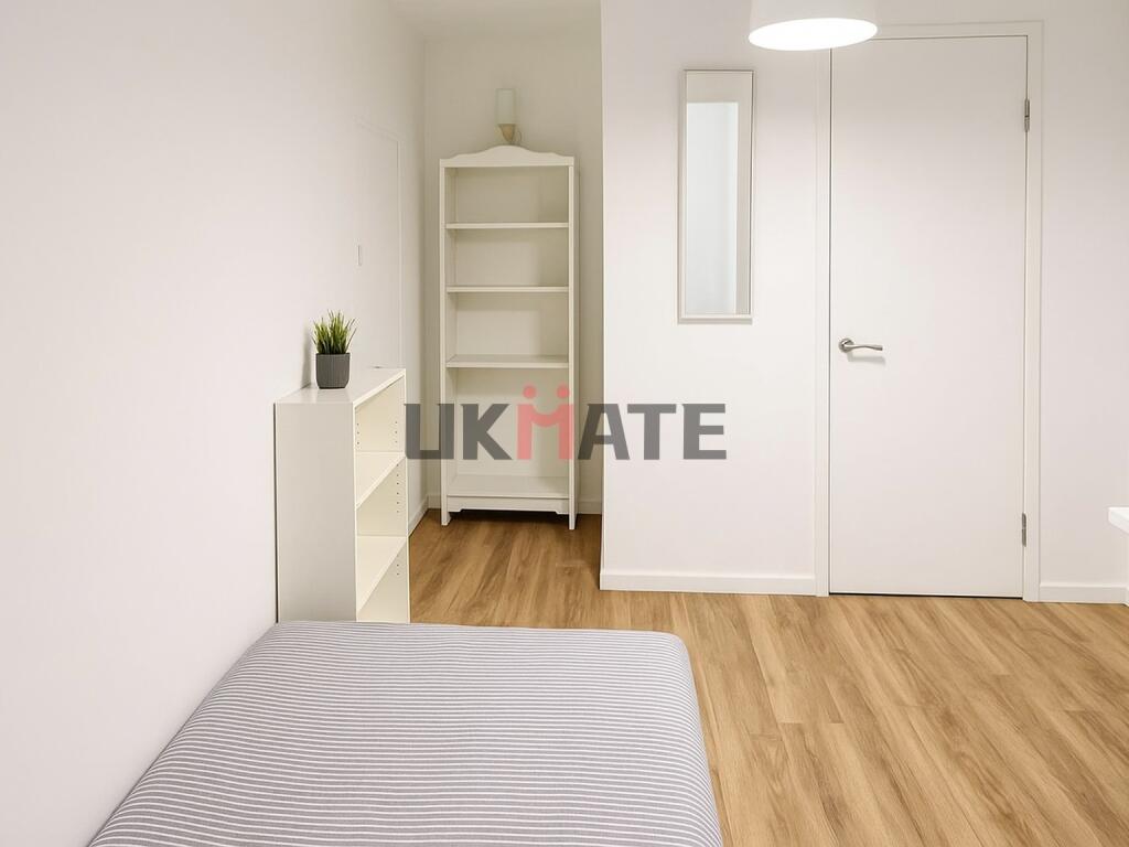 Bright and clean bedroom featuring a comfortabl...
