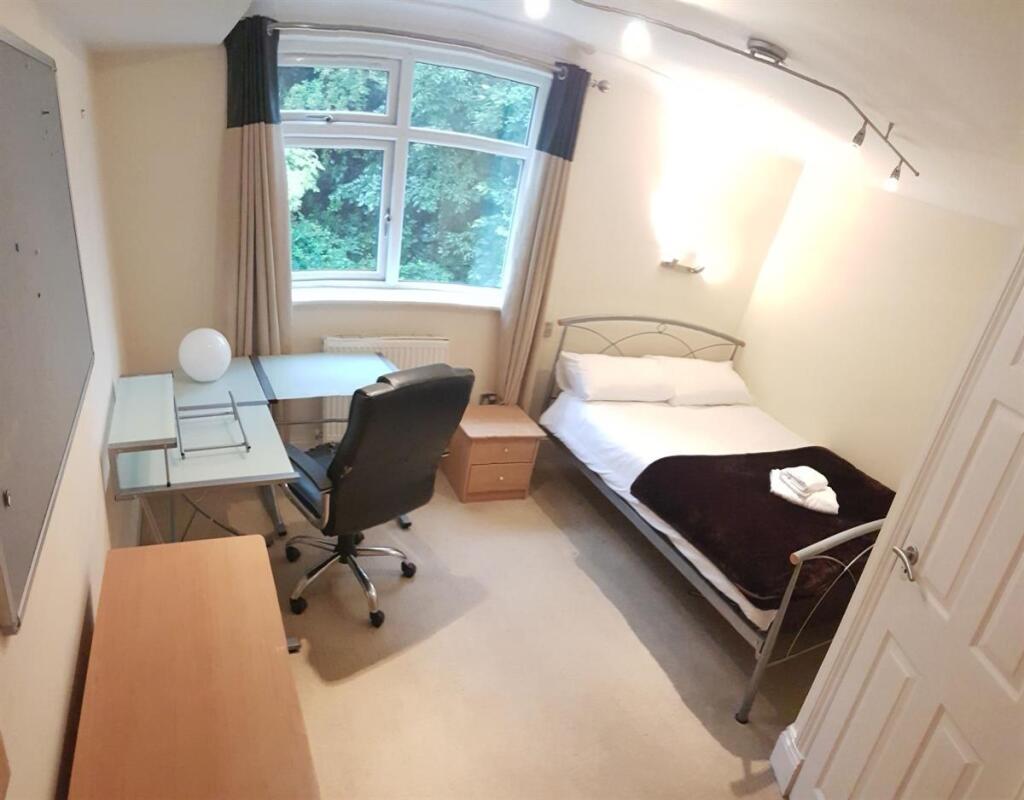 Bright and inviting bedroom featuring a large w...