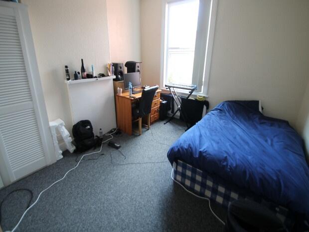 A cozy bedroom featuring a double bed with bedd...