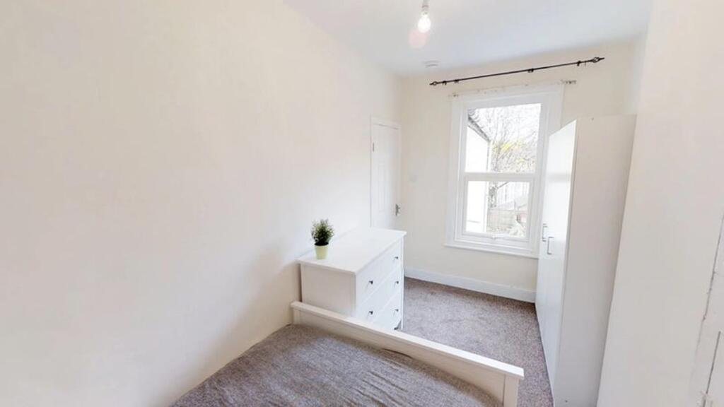 Bright and cozy double bedroom featuring a comf...