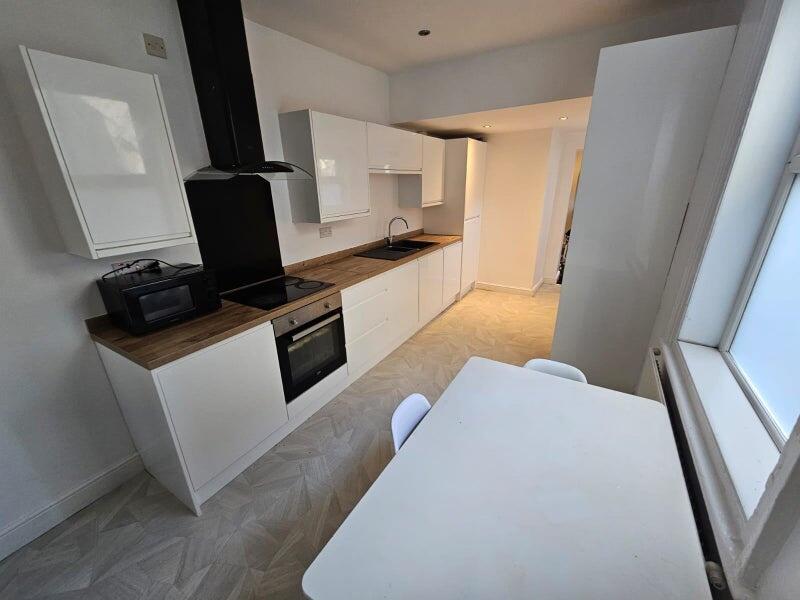 Bright and modern kitchen featuring sleek white...