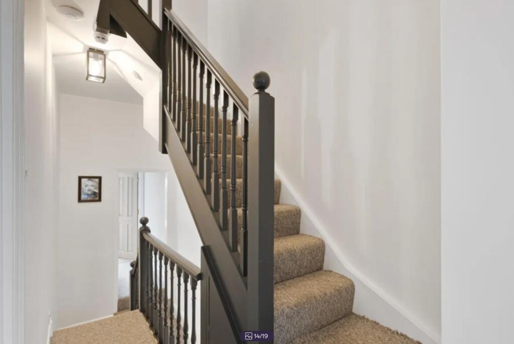 A well-maintained staircase with stylish railin...