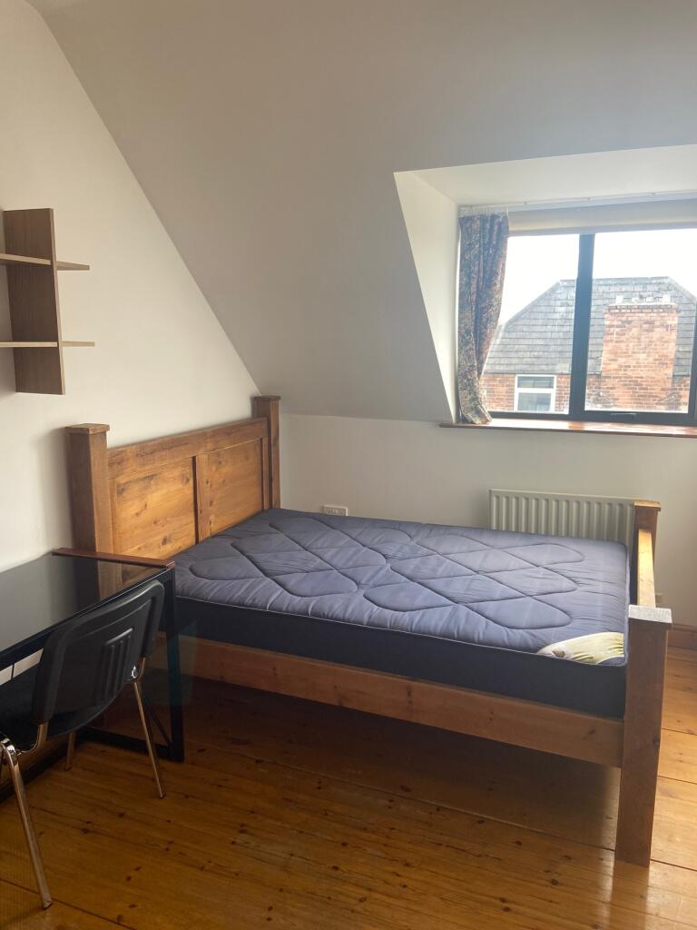 A bright and inviting double bedroom featuring ...